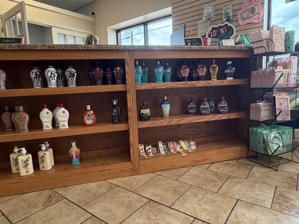 Premium tanning lotions on shelves at Bama Tan Salon in Tuscaloosa, Alabama
